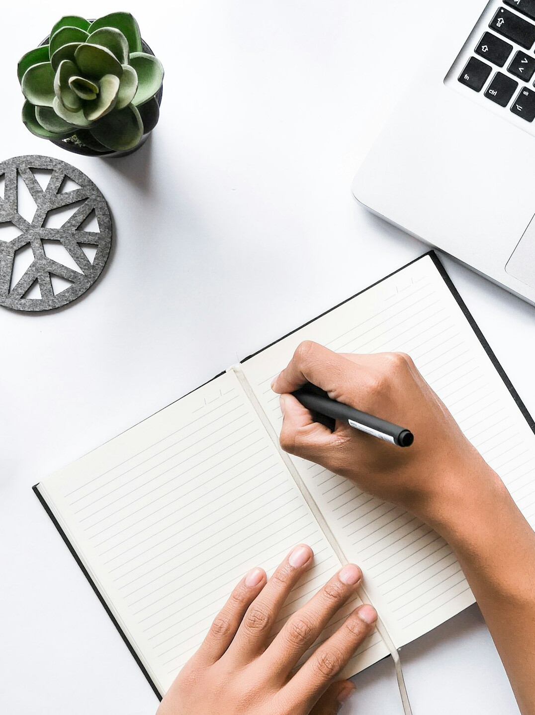person planning day in notebook