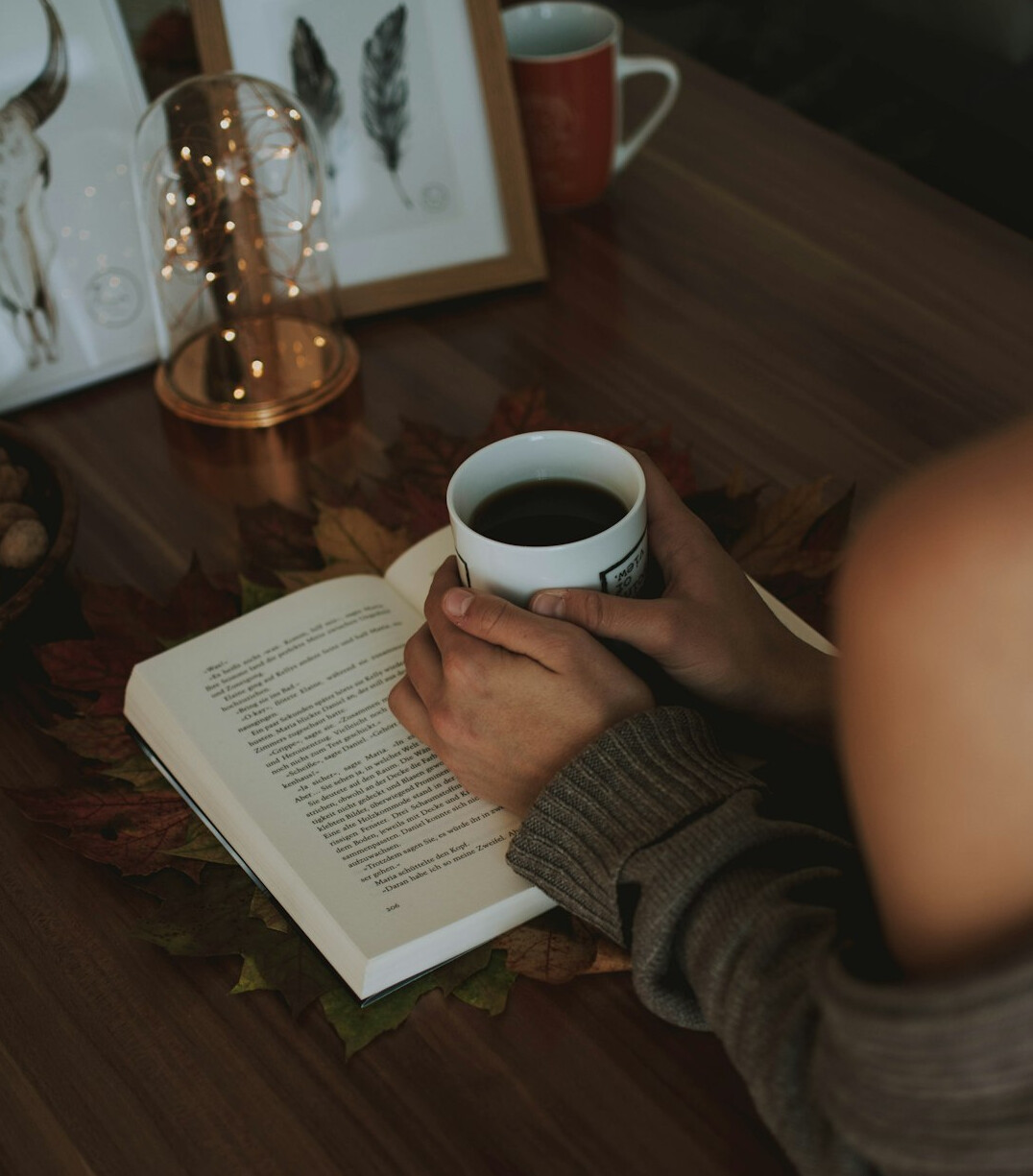 person drinking tea while reading